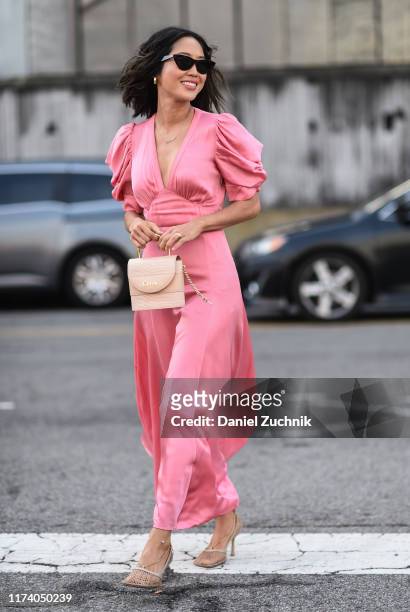 Aimee Song is seen wearing a pink Michael Kors dress outside the Michael Kors show during New York Fashion Week S/S20 on September 11, 2019 in New...