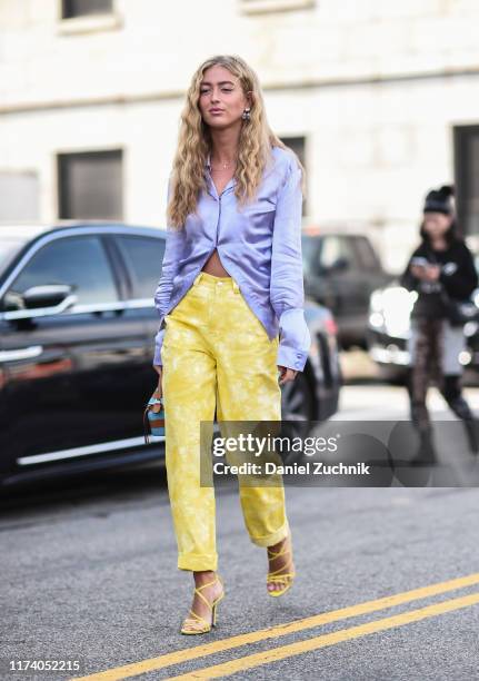 Emili Sindlev is seen wearing a purple top and Michael Kors yellow pants outside the Michael Kors show during New York Fashion Week S/S20 on...