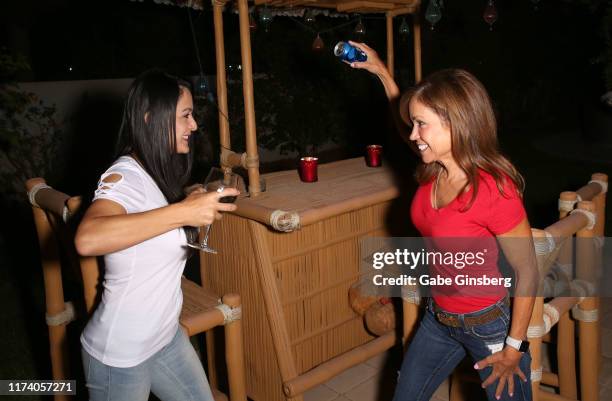 Television personalities Rose Taillie and Susan Brock joke around during a viewing party hosted by Gentille Chhun at her home during the season...