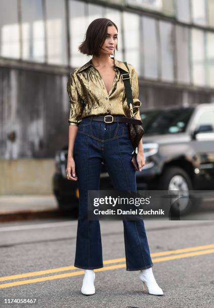 Sarah Ellen is seen wearing a Michael Kors gold top and blue jeans outside the Michael Kors show during New York Fashion Week S/S20 on September 11,...