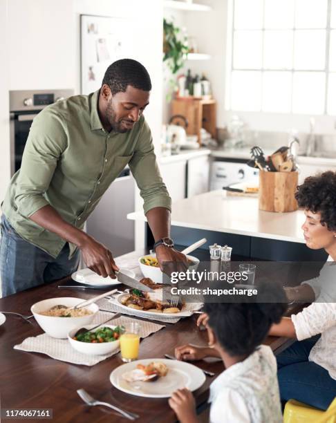 gathered around the table for a tasty sunday lunch - roast chicken table stock pictures, royalty-free photos & images