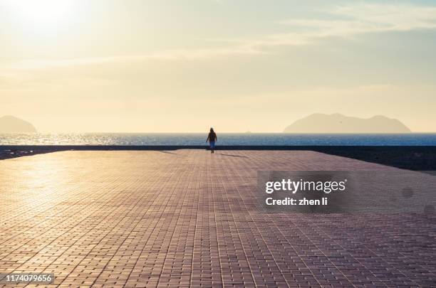 seaside platform against the sunlight - single brick stock pictures, royalty-free photos & images