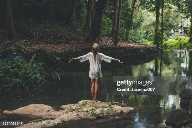 beautiful young woman enjoys in nature - jungle stories stock pictures, royalty-free photos & images