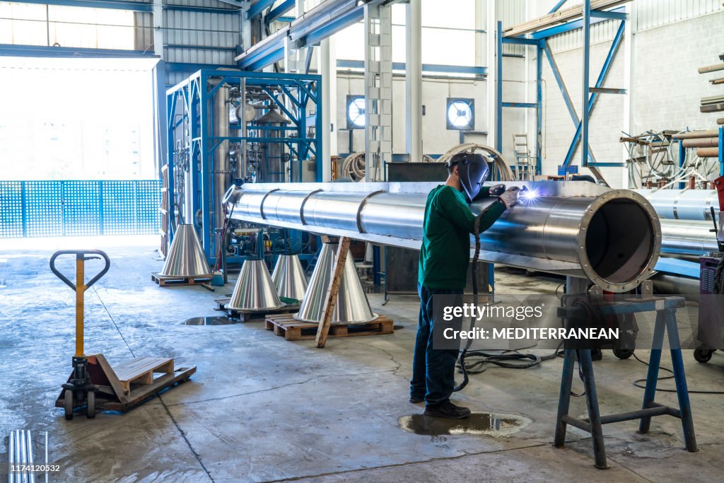 Welder welding stainless steel big pipe