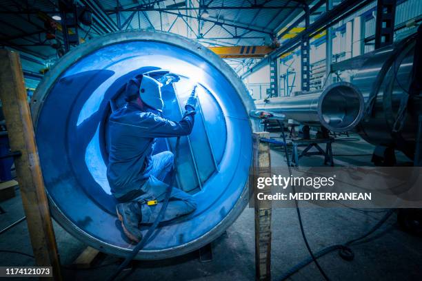 welder man welding stainless steel tank - confined space stock pictures, royalty-free photos & images