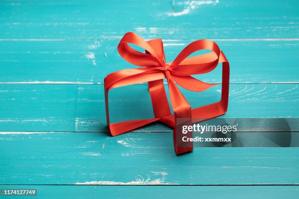 invisible gift box concept on turquoise table - invisible stock pictures, royalty-free photos & images