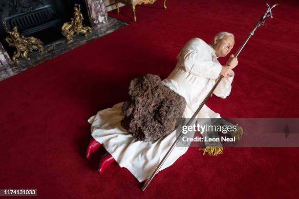 La Nona Ora", a realistic model of Pope John Paul II being hit by a meteorite, created by artist Maurizio Cattelan, is seen at Blenheim Palace on...