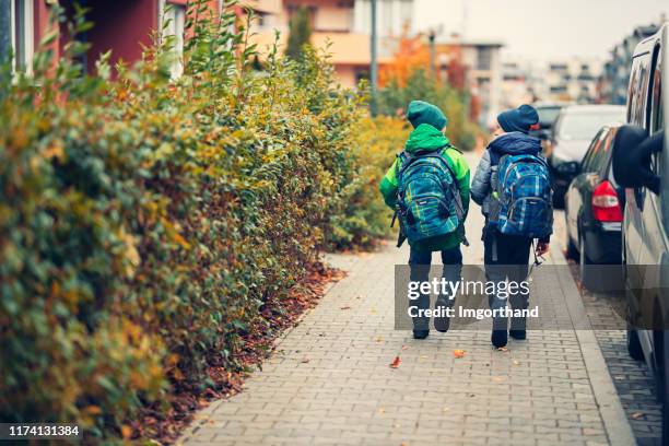 school boys walking to school - school district stock pictures, royalty-free photos & images