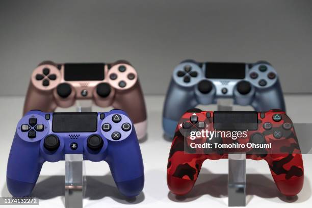 Wireless controllers for the PlayStation 4 game console are displayed in the Sony Interactive Entertainment Inc. Booth on the business day of the...