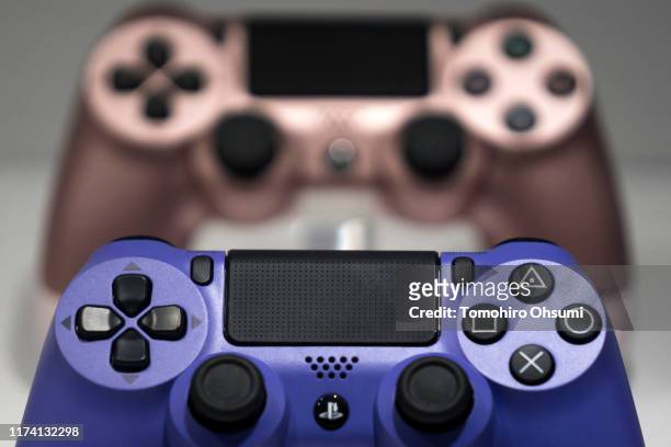 Wireless controller for the PlayStation 4 game console are displayed in the Sony Interactive Entertainment Inc. Booth on the business day of the...
