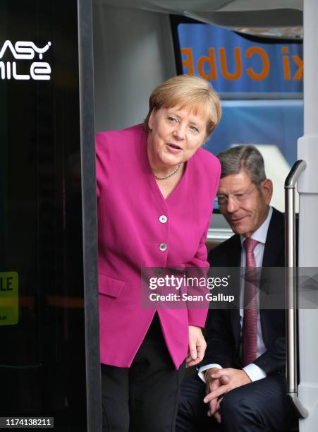 German Chancellor Angela Merkel prepares to ride in an autonomous Robo-Taxi Cube bus at a Continental AG exhibit on the opening day of the IAA 2019...