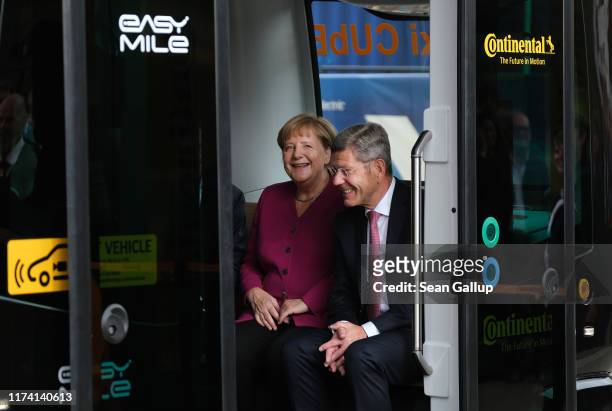 German Chancellor Angela Merkel prepares to ride with Bernhard Mattes, head of the Association of German Auto Industry , in an autonomous Robo-Taxi...
