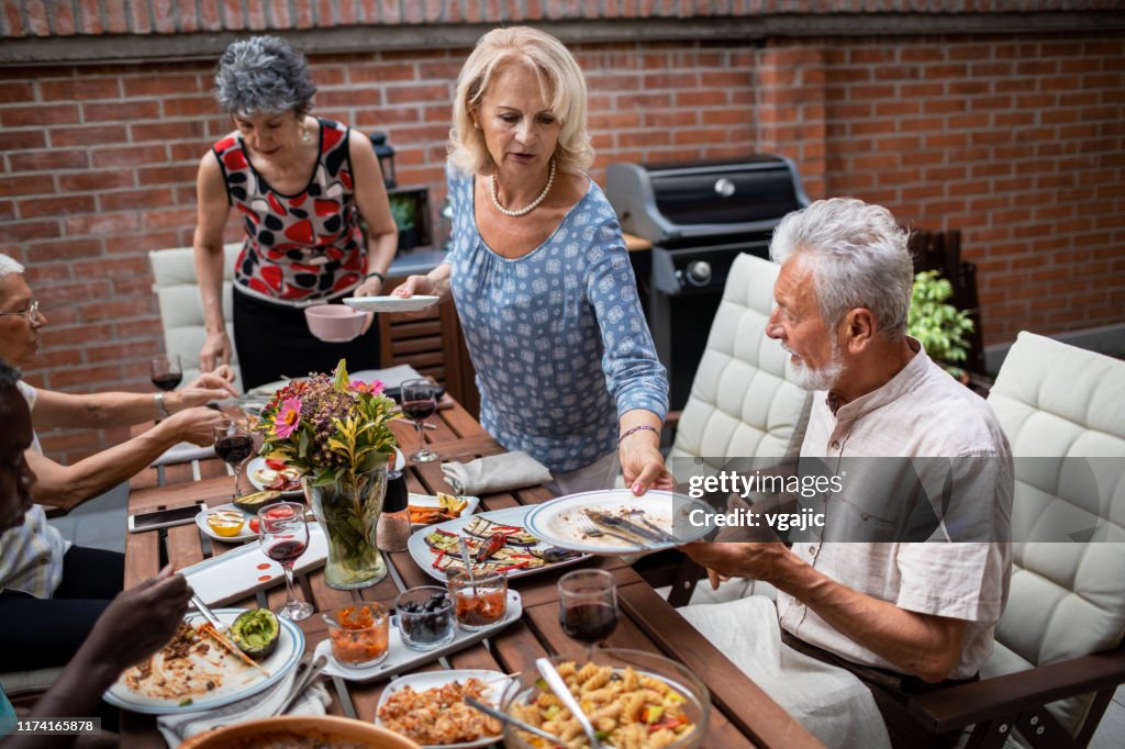 Seniors Cleaning Dinning Table After Vegan BBQ Party