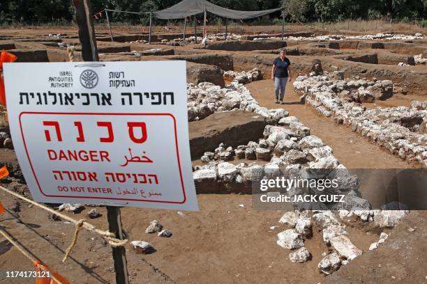 Israeli archaeologist Dina Shalem walks among stone structures at the archaeological site of En Esur where a 5000-year-old city was uncovered, near...