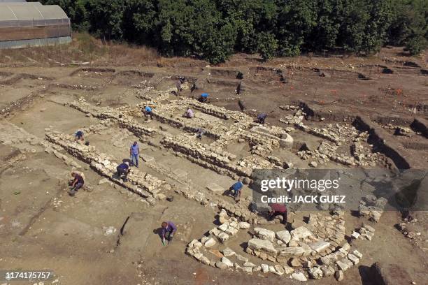 Israeli archaeologists work at the ancient site of En Esur where a 5000-year-old city was uncovered, near the Israeli town of Harish on October 06,...