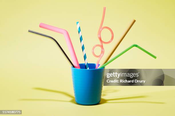six different drinking straws in a cup - straw stock photos et images de collection