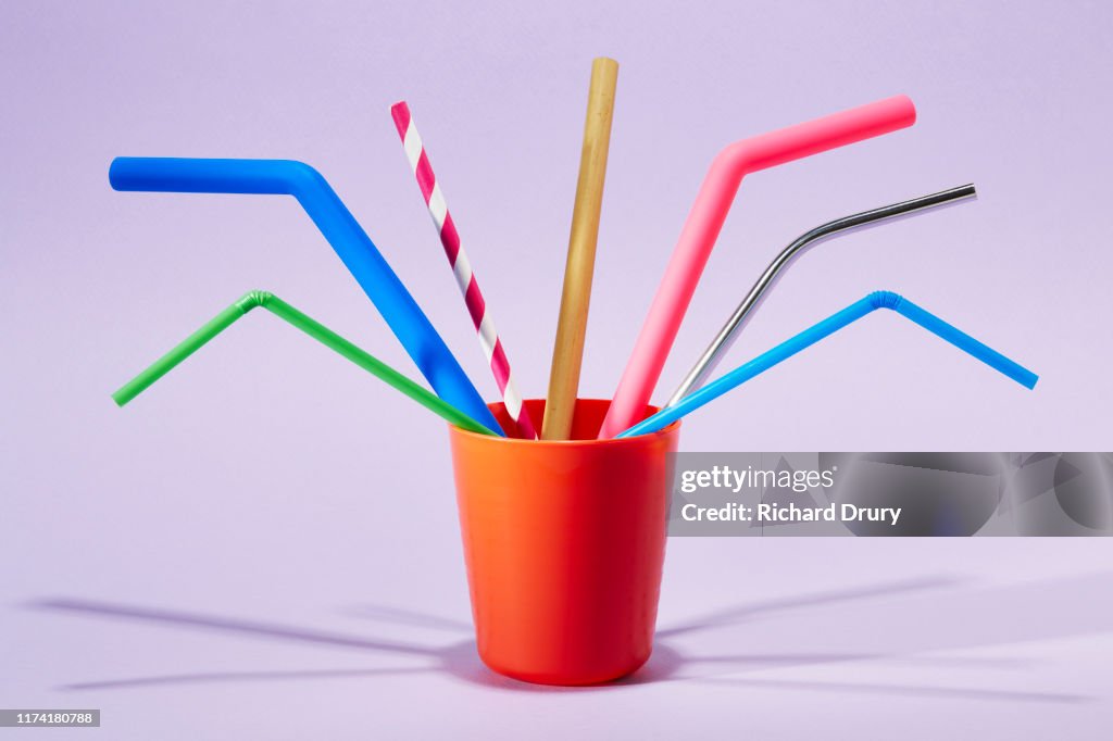Seven different drinking straws in a cup