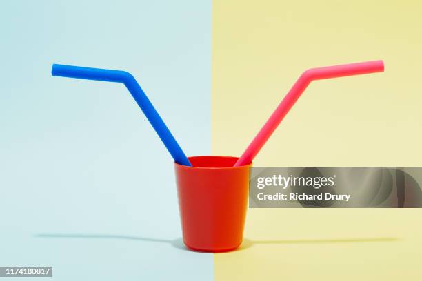 two large silicone drinking straws in a small cup - equal share stock pictures, royalty-free photos & images