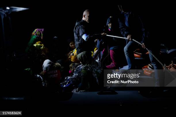 Migrants and refugees arrive at the port of Skala Sikamias, on the Greek island of Lesbos, following a rescue operation by a Frontex patrol vessel as...