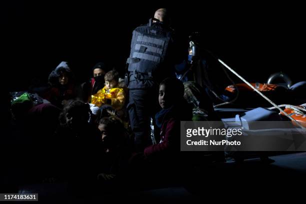 Migrants and refugees arrive at the port of Skala Sikamias, on the Greek island of Lesbos, following a rescue operation by a Frontex patrol vessel as...