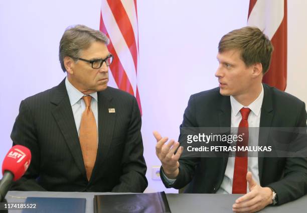 Secretary of Energy Rick Perry talks with Latvian Minister of Economy Ralfs Nemiro after signing an agreement on strengthening energy cooperation...