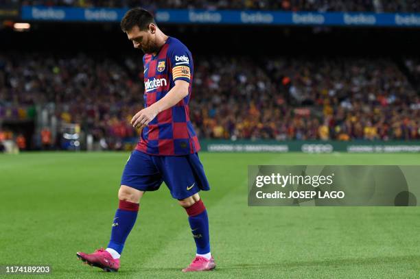 Barcelona's Argentine forward Lionel Messi looks downwards as he leaves the pitch during the Spanish league football match between FC Barcelona and...