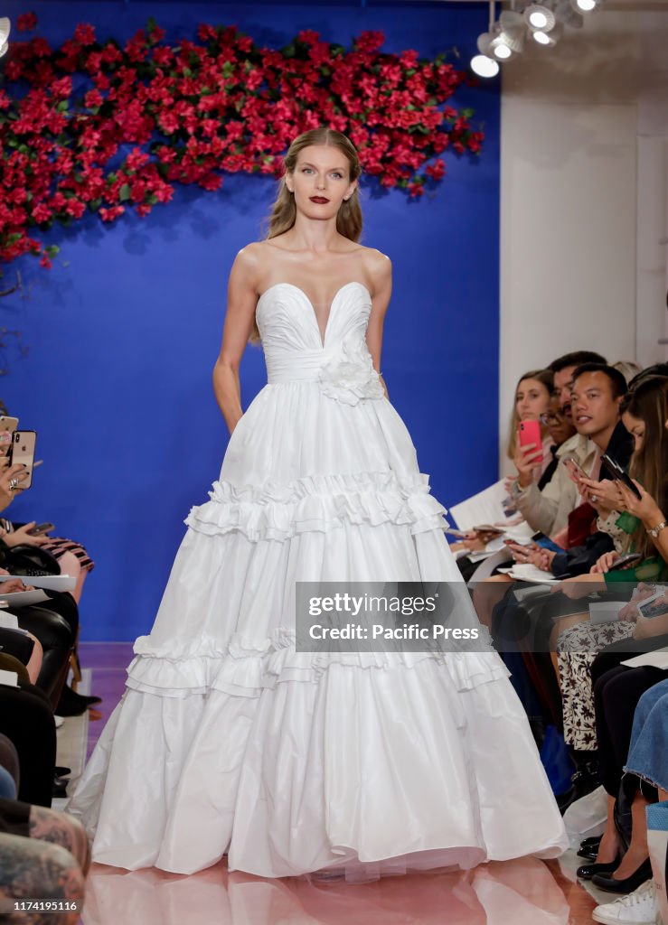 A model walks the runway at the Theia Fall 2020 collection...