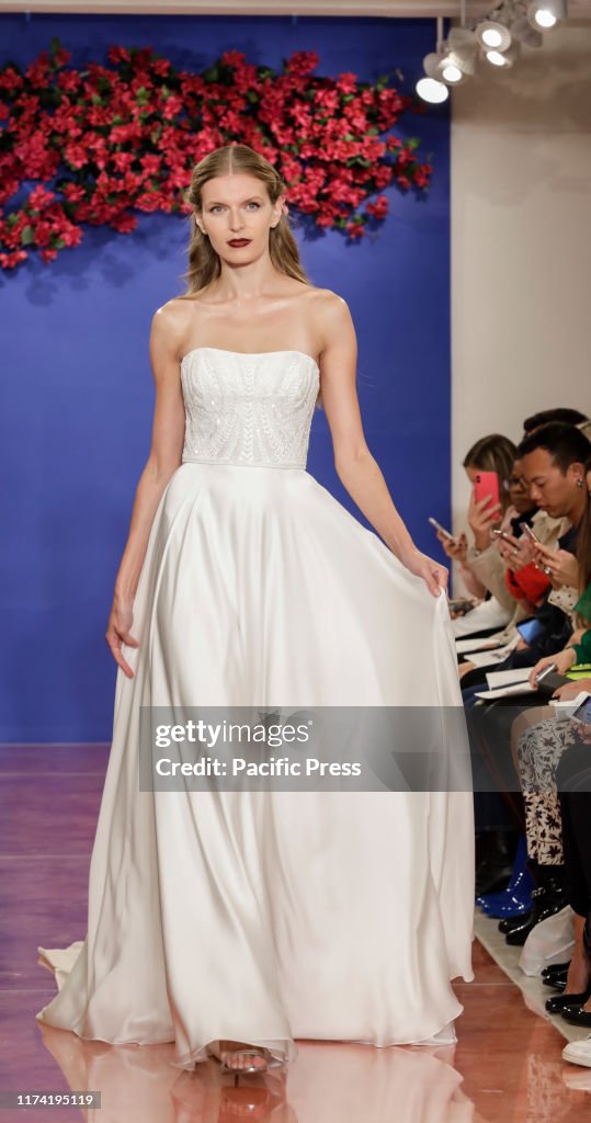 A model walks the runway at the Theia Fall 2020 collection...