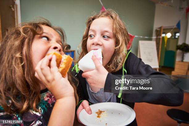 boy and girl eating cake - kid eating restaurant stock pictures, royalty-free photos & images