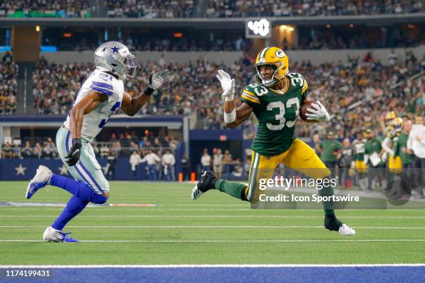 Green Bay Packers running back Aaron Jones makes a waving gesture at Dallas Cowboys cornerback Byron Jones as he rushes for a touchdown during the...