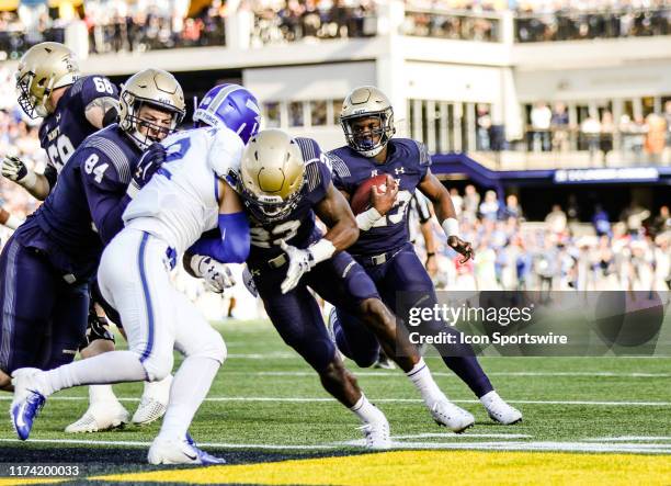 Navy slotback Myles Fells blocks for fullback Nelson Smith allowing Smith to score a touchdown during the first game of the Commander-in-Chiefs...