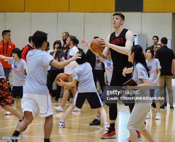 Houston Rockets power forward Isaiah Hartenstein provides instructions during an NBA Cares basketball clinic by the team in Tokyo on October 7, 2019....