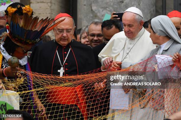 Representatives of the Amazon Rainforest's ethnic groups, Peruvian Cardinal Pedro Ricardo Barreto and Pope Francis march in procession during the...