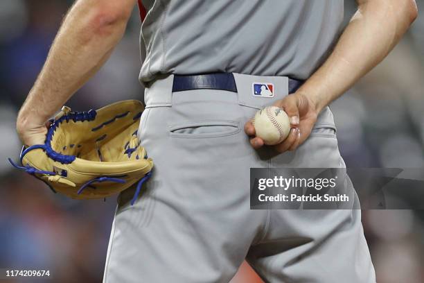 Detail view of a pitcher hold a ball and glove at Oriole Park at Camden Yards on September 11, 2019 in Baltimore, Maryland.