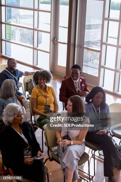 excited business people gather for conference - town hall meeting stock pictures, royalty-free photos & images