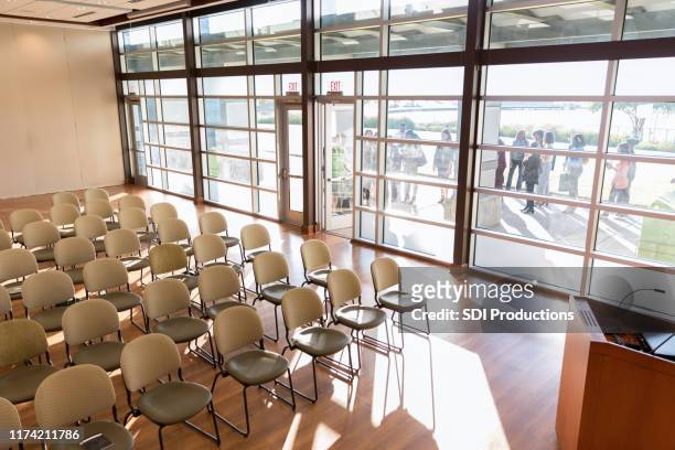 empty room filled with chairs before conference event - town hall meeting stock pictures, royalty-free photos & images