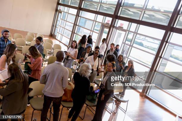 business conference or seminar meet and greet - diverse town hall meeting stock pictures, royalty-free photos & images