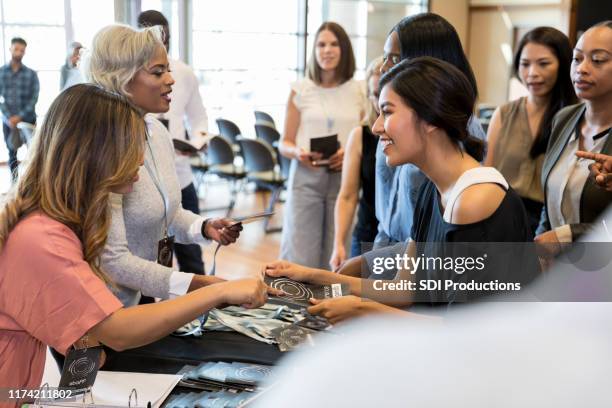 people checking in at conference - diverse town hall meeting stock pictures, royalty-free photos & images