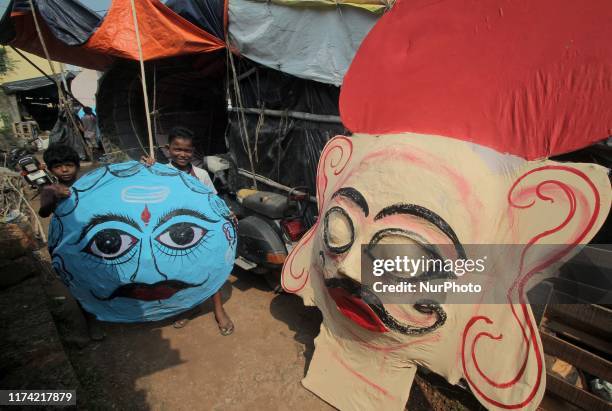 Members of an artistic family prepare masks of the demon king Ravana on the eve of the Indian Hindu festival Dussehera for the end rituals of the...