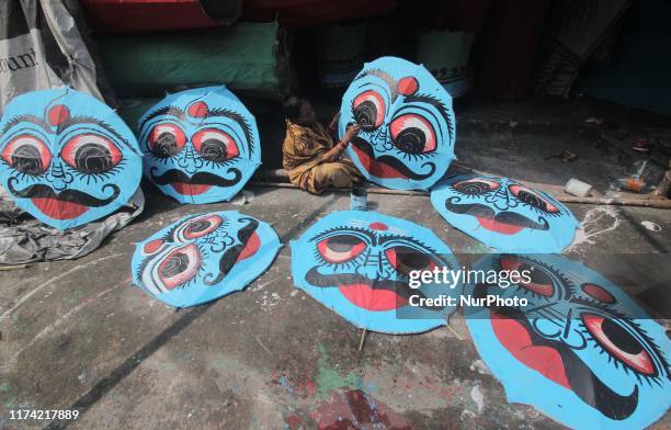 Members of an artistic family prepare masks of the demon king Ravana on the eve of the Indian Hindu festival Dussehera for the end rituals of the...