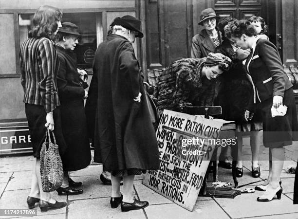 Women sign a petition to demonstrate against ration cuts, in June 1946 in London.