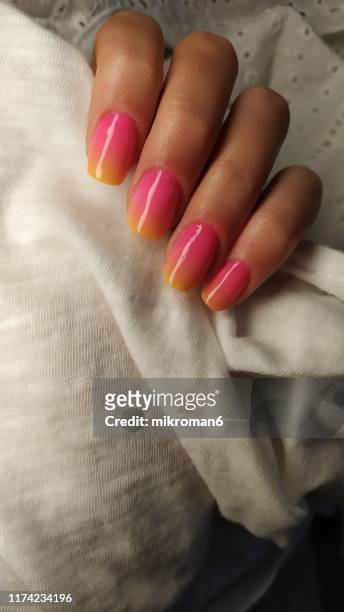 close-up of woman fingers with nail art manicure in ombre colours - nagelkunst stockfoto's en -beelden