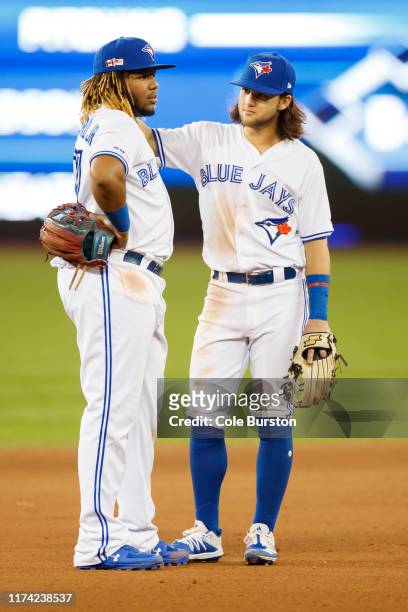 Vladimir Guerrero Jr. #27 and Bo Bichette of the Toronto Blue Jays are seen in the outfield during the ninth inning of their MLB game against the...