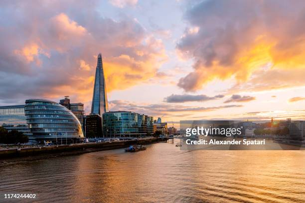 dramatic sunset in london with thames river, shard skyscraper and london city hall, england, uk - guildhall london stock pictures, royalty-free photos & images