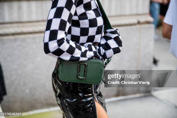 Mary Leest is seen wearing skirt with zipper, black white plaid cropped top, green bag outside Marc Jacobs during New York Fashion Week September...