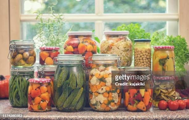 pickled organic vegetables in jars - pickle jar stock pictures, royalty-free photos & images