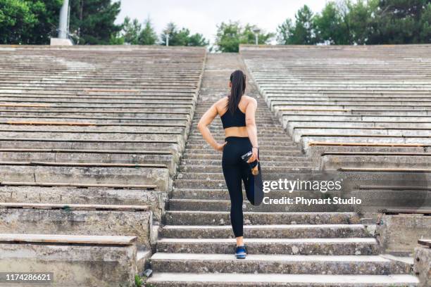 woman preparing for run up the stairs - leggings stock pictures, royalty-free photos & images