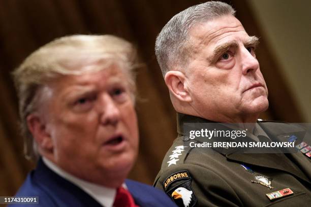 Chairman of the Joint Chiefs of Staff Army General Mark A. Milley listens while US President Donald Trump speaks before a meeting with senior...