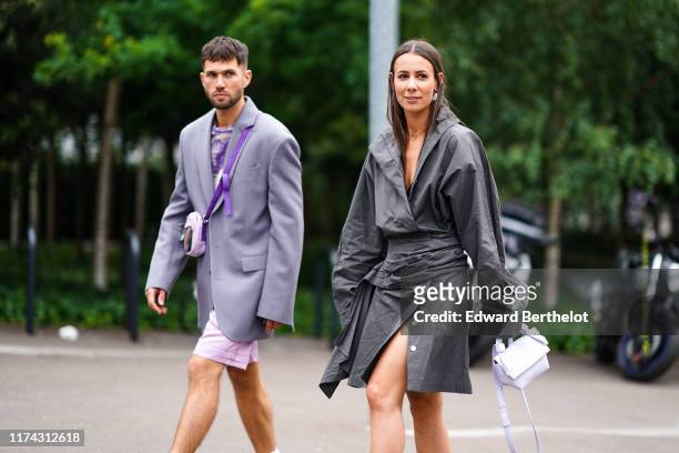 Jean-Sebastien Rocques wears a light grey jacket, a white and purple tie-and-dye top, pale pink shorts, a pale pink and light brown bag ; Alice...