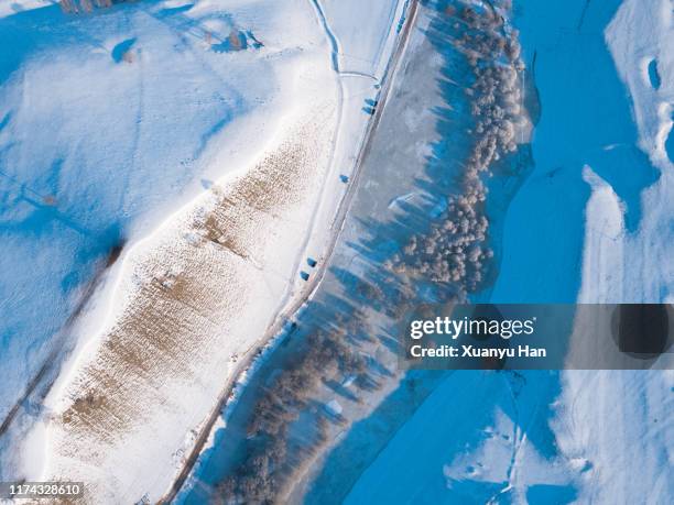 aerial view of car driving in remote snow covered landscape - dramatic landscape stock pictures, royalty-free photos & images